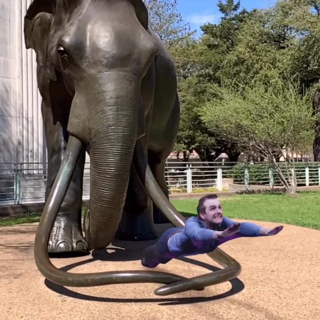 AR Capture 02: a captured guest flying beside an outdoor elephant sculpture