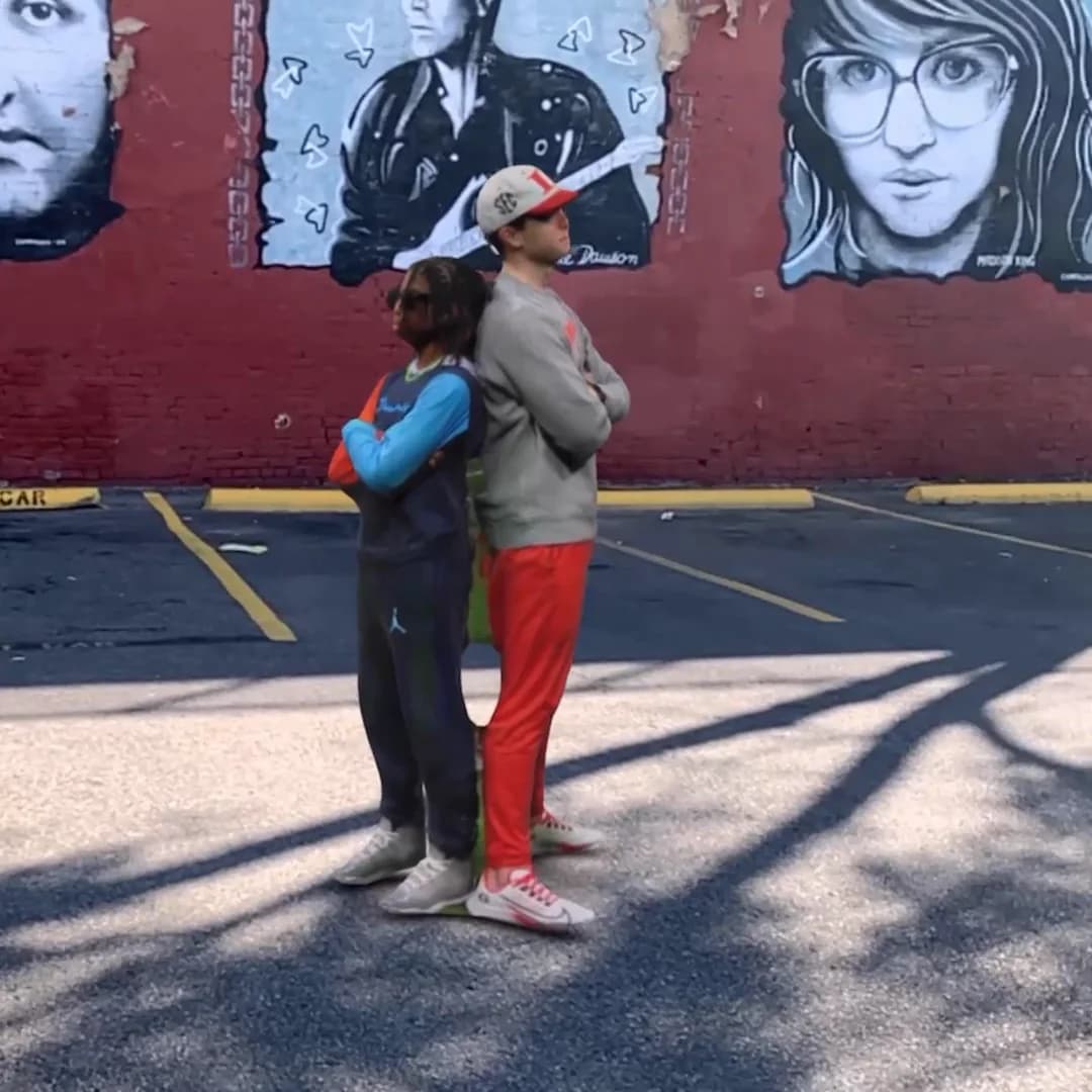 AR Capture 03: two captured guests standing back to back in front of an outdoor mural