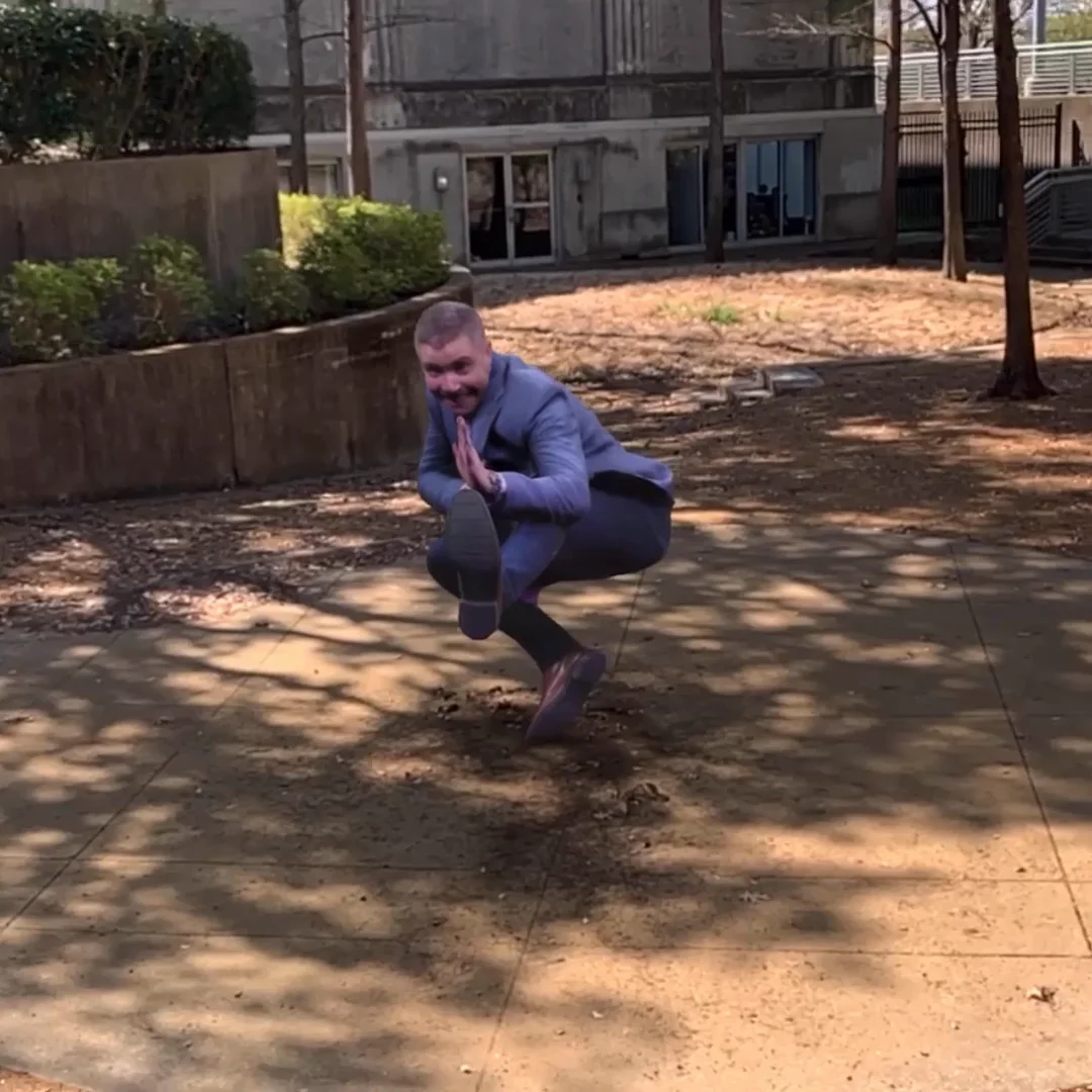 AR Capture 05: a captured guest frozen in a crouching pose in an outdoor courtyard